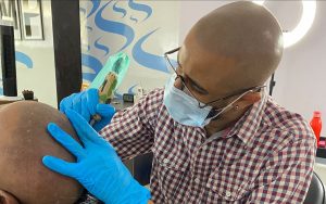 Scalp Micropigmentation Specialist Performing the Procedure